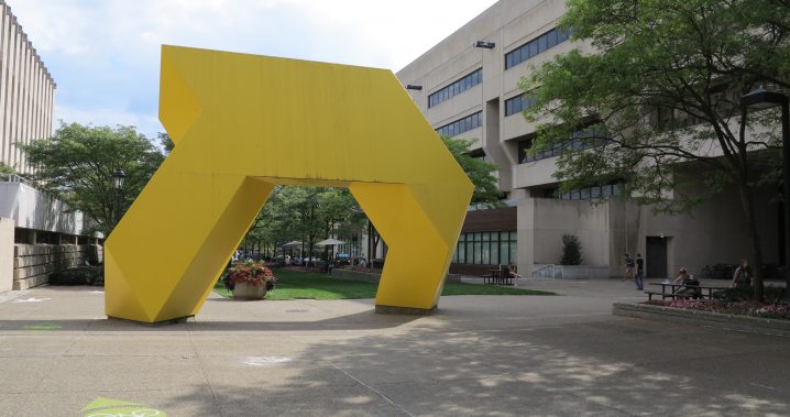 Yellow art sculpture next to the Barco Law Building on campus. Artist - Tony Smith, Light Up! 1971, Painted Steel